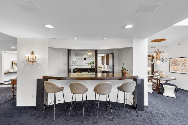3145 Dean Ct Unit 1100, Minneapolis, MN 55416 - kitchen with dark colored carpet, a kitchen bar, recessed lighting, and hanging light fixtures