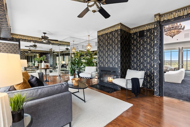 3145 Dean Ct Unit 1100, Minneapolis, MN 55416 - living room with ceiling fan, wood finished floors, a chandelier, and a tiled fireplace
