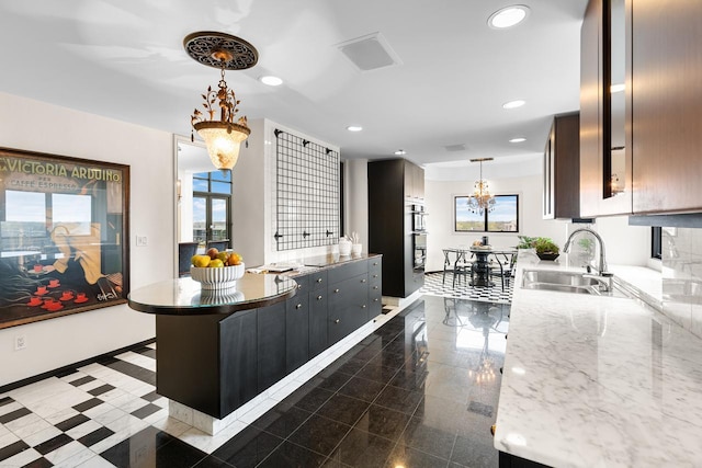 3145 Dean Ct Unit 1100, Minneapolis, MN 55416 - kitchen featuring a sink, baseboards, double oven, recessed lighting, and hanging light fixtures