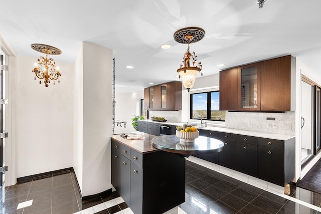 3145 Dean Ct Unit 1100, Minneapolis, MN 55416 - kitchen featuring backsplash, glass insert cabinets, dishwasher, a chandelier, and decorative light fixtures