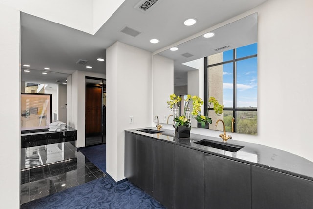 3145 Dean Ct Unit 1100, Minneapolis, MN 55416 - bar featuring a sink, recessed lighting, and granite tiled floors
