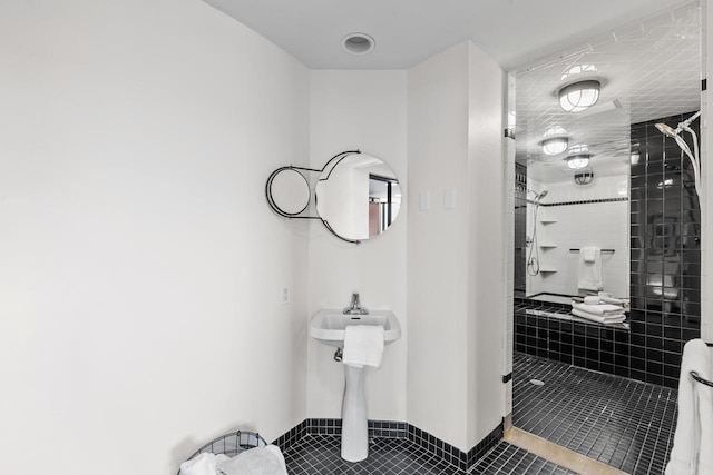 3145 Dean Ct Unit 1100, Minneapolis, MN 55416 - bathroom featuring tile patterned flooring, tiled shower, and a sink