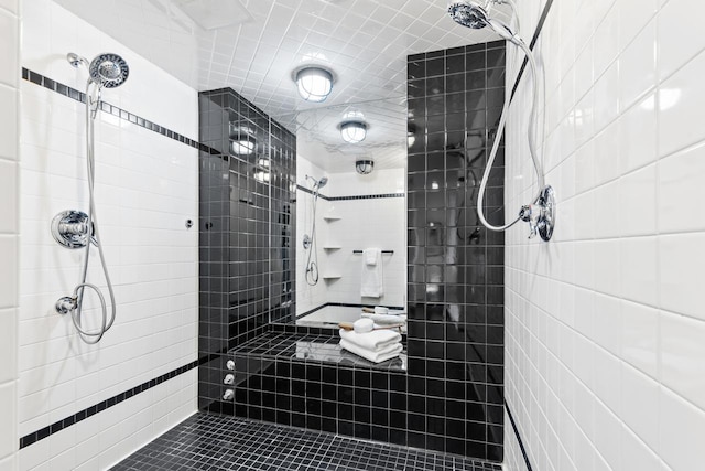 3145 Dean Ct Unit 1100, Minneapolis, MN 55416 - bathroom featuring tile walls, tiled shower, and tile patterned floors