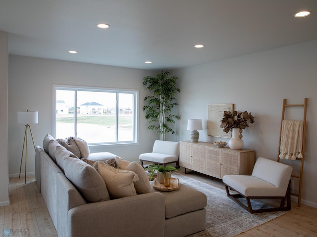 living area with recessed lighting, light wood finished floors, and baseboards