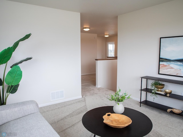 living area featuring visible vents, baseboards, and carpet floors