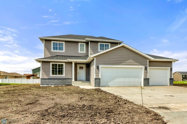 3445 18th St S, Moorhead, MN 56560 - traditional-style house featuring a garage, brick siding, fence, concrete driveway, and a shingled roof