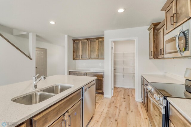 3445 18th St S, Moorhead, MN 56560 - kitchen with light wood-style floors, a sink, appliances with stainless steel finishes, and recessed lighting