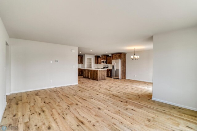3445 18th St S, Moorhead, MN 56560 - unfurnished living room featuring recessed lighting, baseboards, light wood-type flooring, and a chandelier