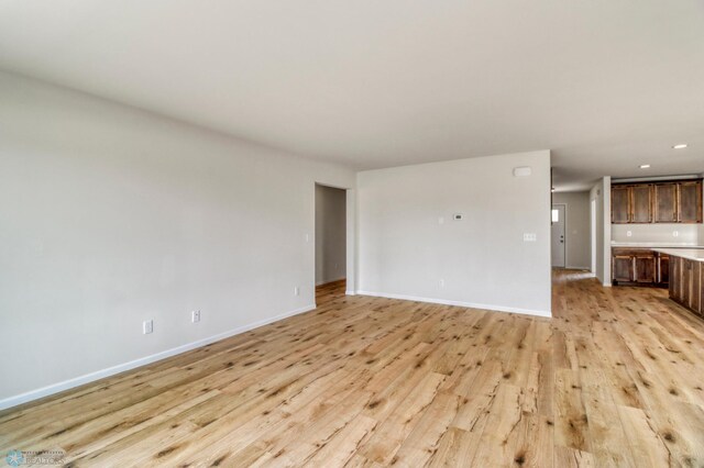 3445 18th St S, Moorhead, MN 56560 - unfurnished living room featuring recessed lighting, baseboards, and light wood finished floors