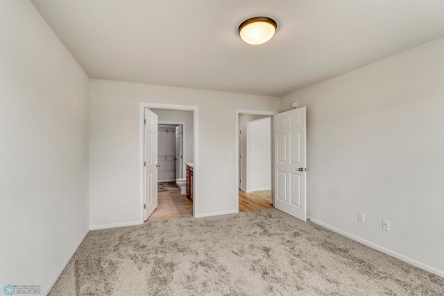 3445 18th St S, Moorhead, MN 56560 - unfurnished bedroom featuring baseboards and carpet