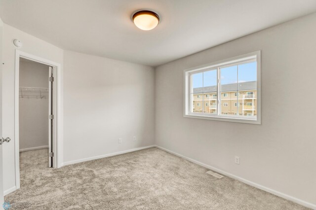 3445 18th St S, Moorhead, MN 56560 - unfurnished bedroom featuring carpet, baseboards, a spacious closet, visible vents, and a closet