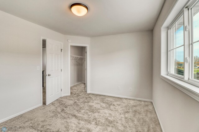 3445 18th St S, Moorhead, MN 56560 - unfurnished bedroom featuring baseboards, a spacious closet, carpet, and a closet