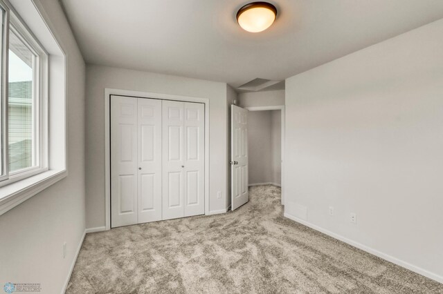 3445 18th St S, Moorhead, MN 56560 - unfurnished bedroom featuring carpet floors, baseboards, and a closet