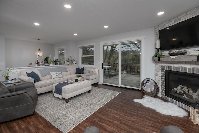 living area with visible vents, a fireplace, recessed lighting, and dark wood-type flooring