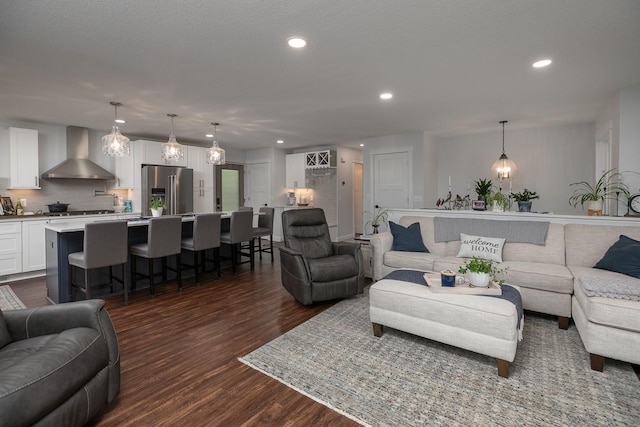living room featuring dark wood-type flooring and recessed lighting