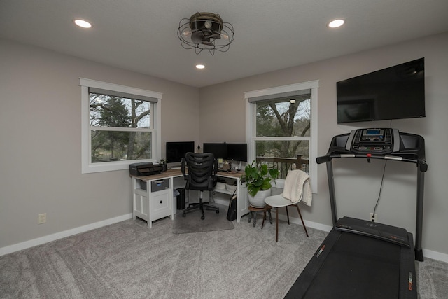 office space featuring baseboards, carpet flooring, and a healthy amount of sunlight