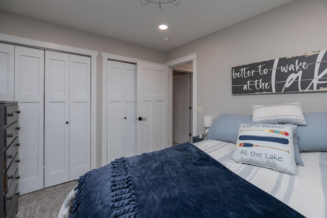 bedroom featuring multiple closets, carpet flooring, and recessed lighting