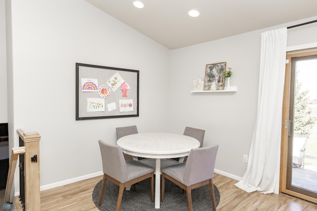dining area featuring baseboards, recessed lighting, light wood-style flooring, and vaulted ceiling