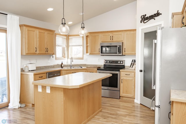 kitchen with light wood-type flooring, a sink, appliances with stainless steel finishes, and light brown cabinets