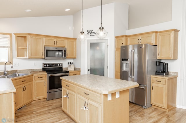 kitchen with a sink, light wood-style flooring, appliances with stainless steel finishes, and light brown cabinets