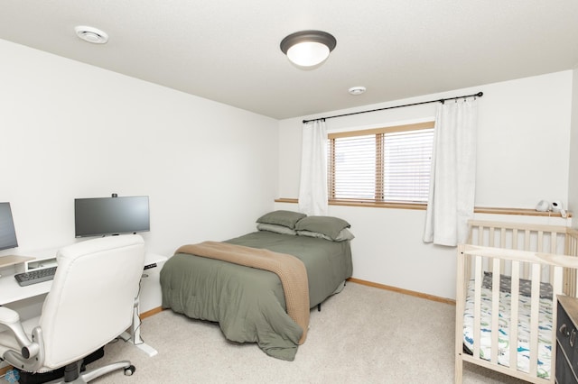 carpeted bedroom with baseboards