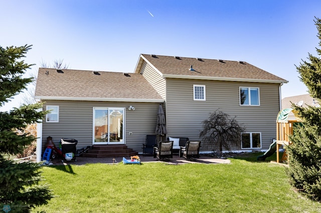 back of house featuring a lawn, a patio, a shingled roof, and entry steps