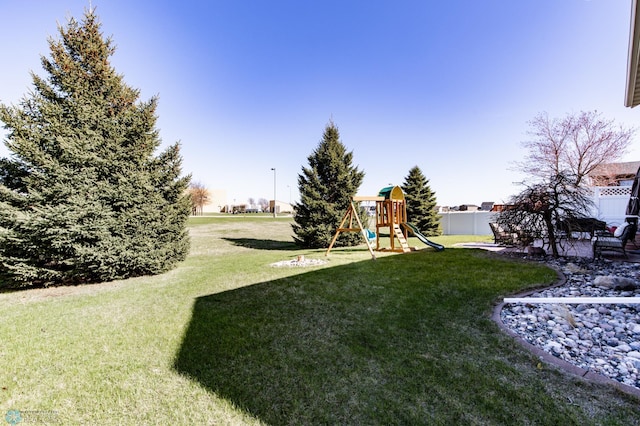 view of yard featuring a playground and fence