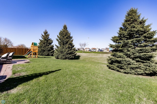 view of yard with a playground and fence