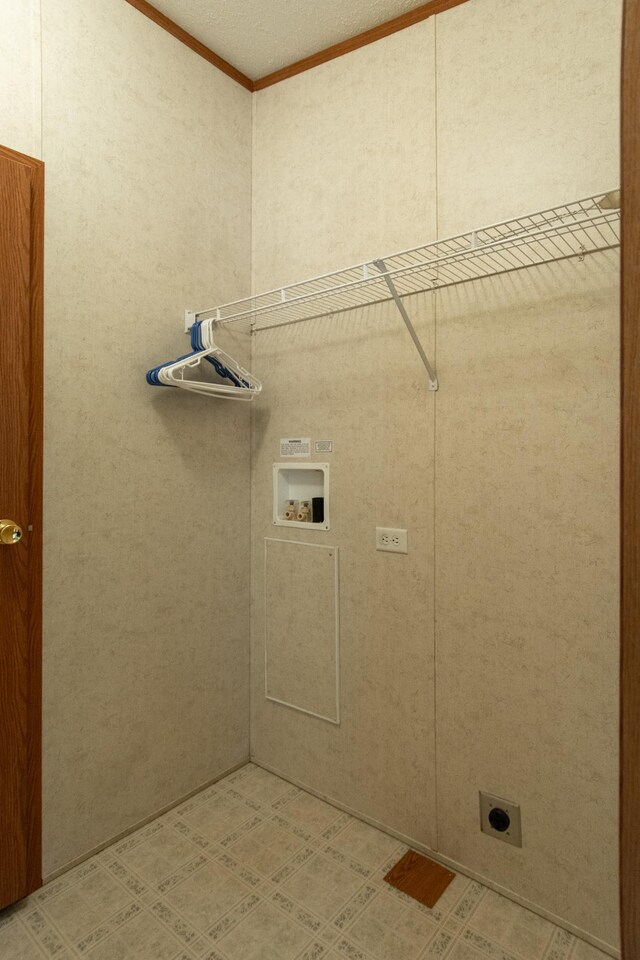 clothes washing area featuring crown molding, washer hookup, hookup for an electric dryer, and laundry area