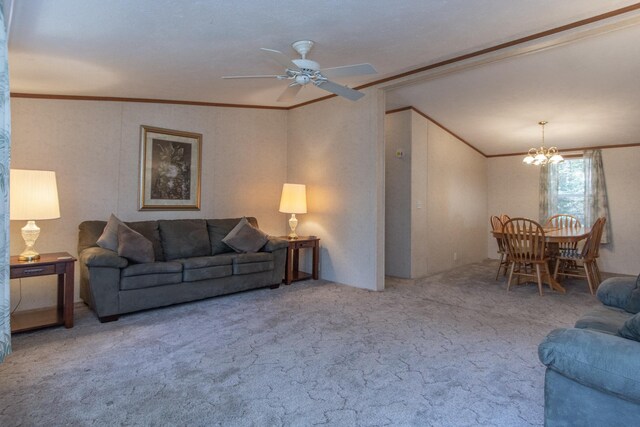 carpeted living area with vaulted ceiling, ornamental molding, and ceiling fan with notable chandelier