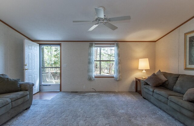 living room with crown molding, carpet, and plenty of natural light