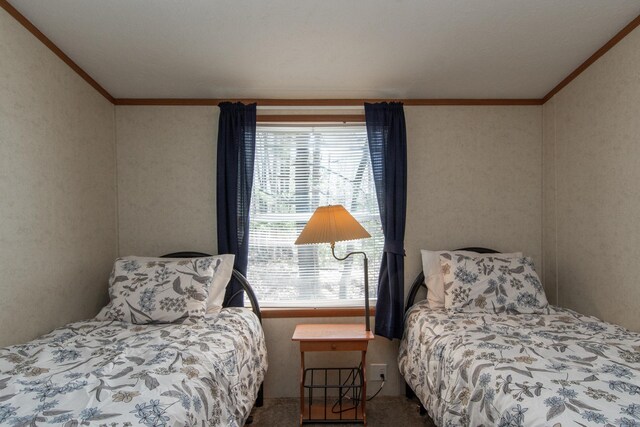 carpeted bedroom featuring crown molding