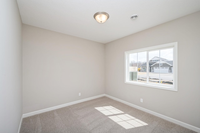 empty room with baseboards and carpet
