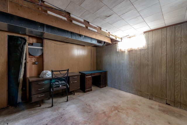 finished below grade area featuring wood walls