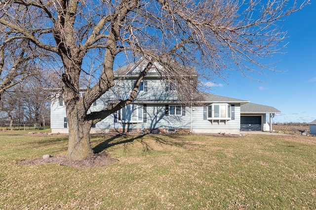 view of front facade featuring an attached garage and a front lawn