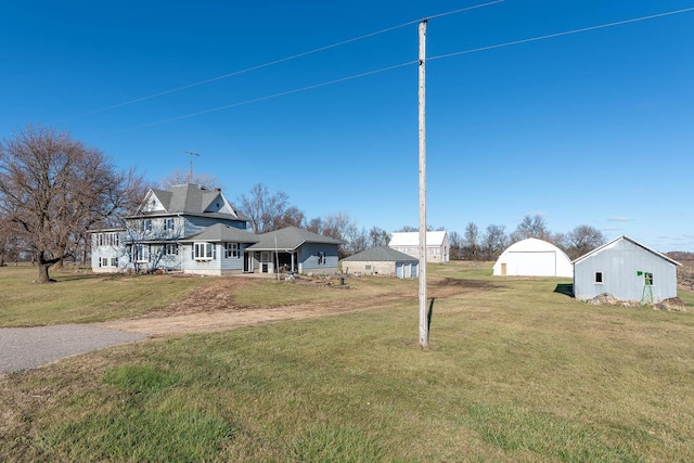 view of yard with a pole building and an outbuilding