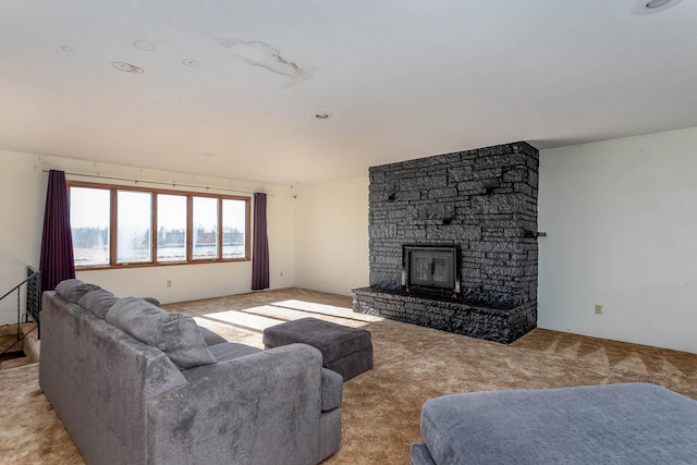 living area featuring light colored carpet and a fireplace