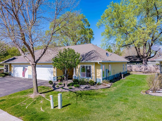 view of front facade with asphalt driveway, a garage, and roof with shingles