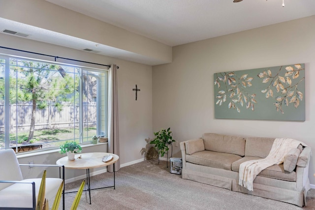 living room with carpet flooring, plenty of natural light, and baseboards