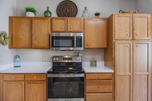 kitchen with appliances with stainless steel finishes and light countertops
