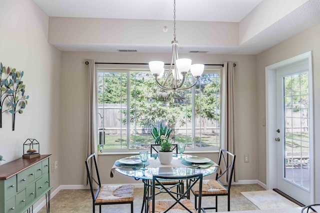 dining room with a chandelier and light tile patterned flooring