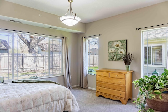 bedroom featuring light carpet and baseboards