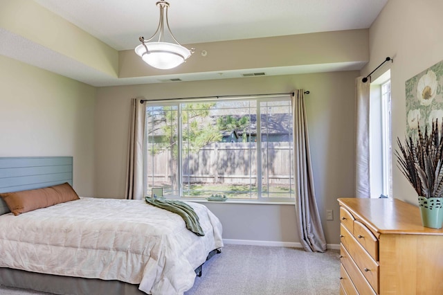bedroom featuring baseboards and light carpet