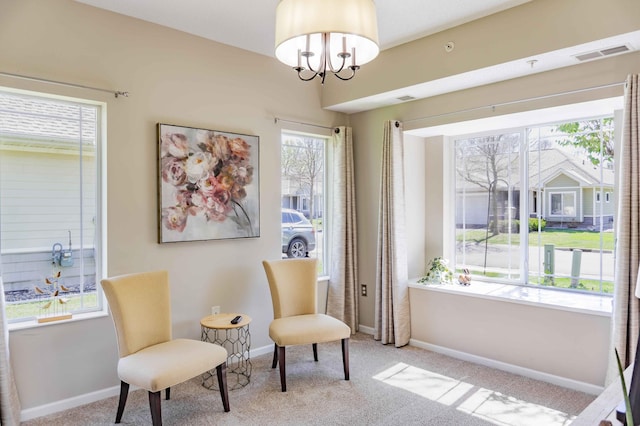 sitting room featuring carpet floors, baseboards, and a chandelier