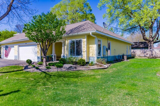 view of front of home featuring a garage, driveway, and a shingled roof