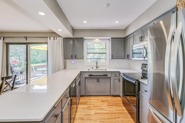 720 Mercury Dr W, Shoreview, MN 55126 - kitchen featuring stainless steel appliances, gray cabinetry, a peninsula, recessed lighting, and light wood-type flooring