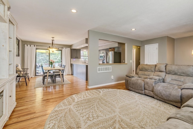 720 Mercury Dr W, Shoreview, MN 55126 - living room featuring light wood finished floors and recessed lighting