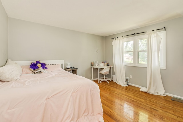720 Mercury Dr W, Shoreview, MN 55126 - bedroom featuring light wood-style flooring and baseboards