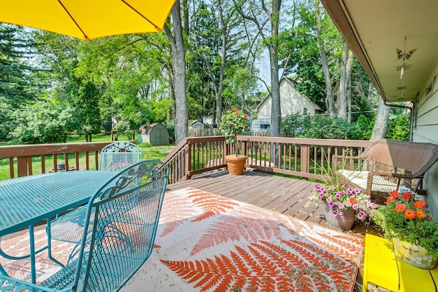 720 Mercury Dr W, Shoreview, MN 55126 - wooden deck with a shed, outdoor dining area, and view of wooded area