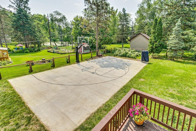 720 Mercury Dr W, Shoreview, MN 55126 - view of sport court featuring basketball hoop and view of wooded area
